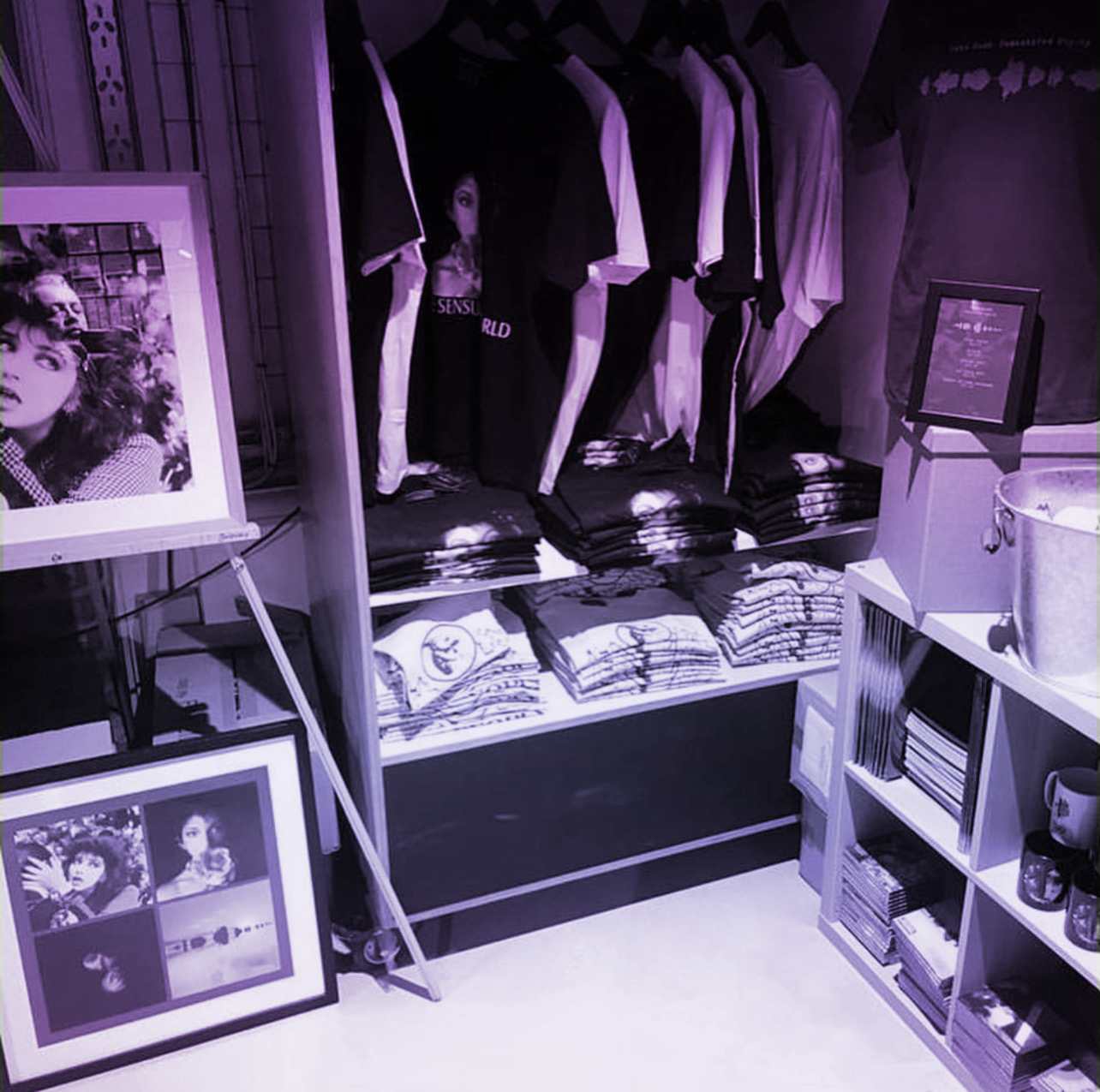 A walk-in closet with Kate Bush t-shirts, framed album covers and coffee mugs 